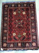 A Caucasian geometric red ground rug, 150 x 115cm