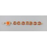 Part of an early 20th century yellow metal and carnelian disc link set bracelet, 14.6cm, gross