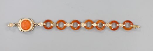 Part of an early 20th century yellow metal and carnelian disc link set bracelet, 14.6cm, gross