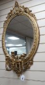 A Victorian oval giltwood and gesso girandole, width 56cm, height 97cm