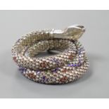 A continental 935 white metal and polychrome enamel set coiled serpent bangle.