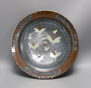 David Frith for Brookhouse Pottery - a circular stoneware charger with leaf and berry decoration.