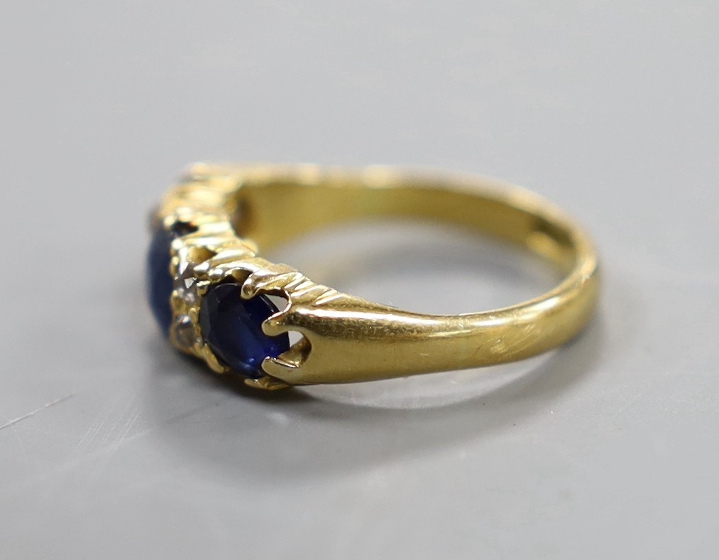 An 18ct, three stone sapphire and four stone diamond chip set half hoop ring, size L, gross weight 4 - Image 2 of 3
