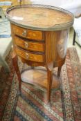 An early 20th century French marquetry oval three drawer small chest, width 50cm, depth 36cm, height