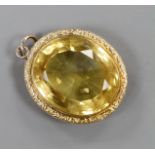 A yellow metal mounted oval cut citrine pendant, overall 49mm, gross weight 23.3 grams.