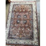 A North West Persian style brick red ground rug, 190 x 126cm