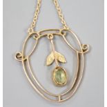 An Edwardian 9ct, peridot and seed pearl set drop pendant, 25mm, gross weight 1.6 grams.