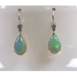 A pair of white metal, opal and diamond set earrings, overall 25mm, gross weight 2.6 grams.