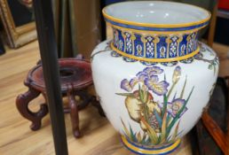 A Gien faience vase, painted with irises, raised on a hardwood stand, 68cm total height