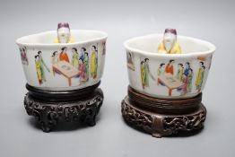 A pair of 19th century Chinese famille rose puzzle cups on stands, 8cm tall overall