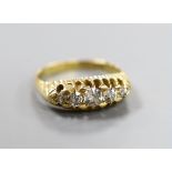 An Edwardian 18ct gold and graduated five stone diamond set half hoop ring, size P, gross weight 4.9