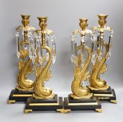 A set of four bronze dolphin and lustre candlesticks,42 cms high,