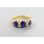 An 18ct, three stone sapphire and four stone diamond chip set half hoop ring, size L, gross weight 4