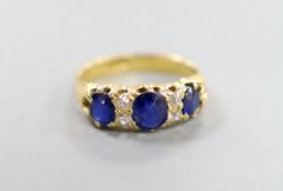 An 18ct, three stone sapphire and four stone diamond chip set half hoop ring, size L, gross weight 4