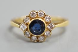 A modern 18ct gold, collet set sapphire and diamond set circular cluster ring, size O, gross