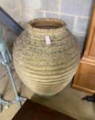 A large Grecian style circular earthenware oil jar (broken in two), height 84cm