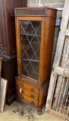 A 1920's narrow oak leaded glazed bookcase, width 52cm, depth 32cm, height 151cm