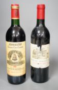 Two bottles of wine: Chateau Magdelaine St. Emilion Grand Cru 1990 and Chateau Angelus St Emilion