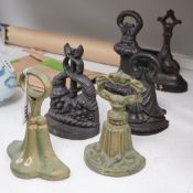 A group of six assorted cast iron Victorian door stops, two later painted, 26cm tall