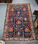 An antique Caucasian blue ground rug, 194 x 132cm