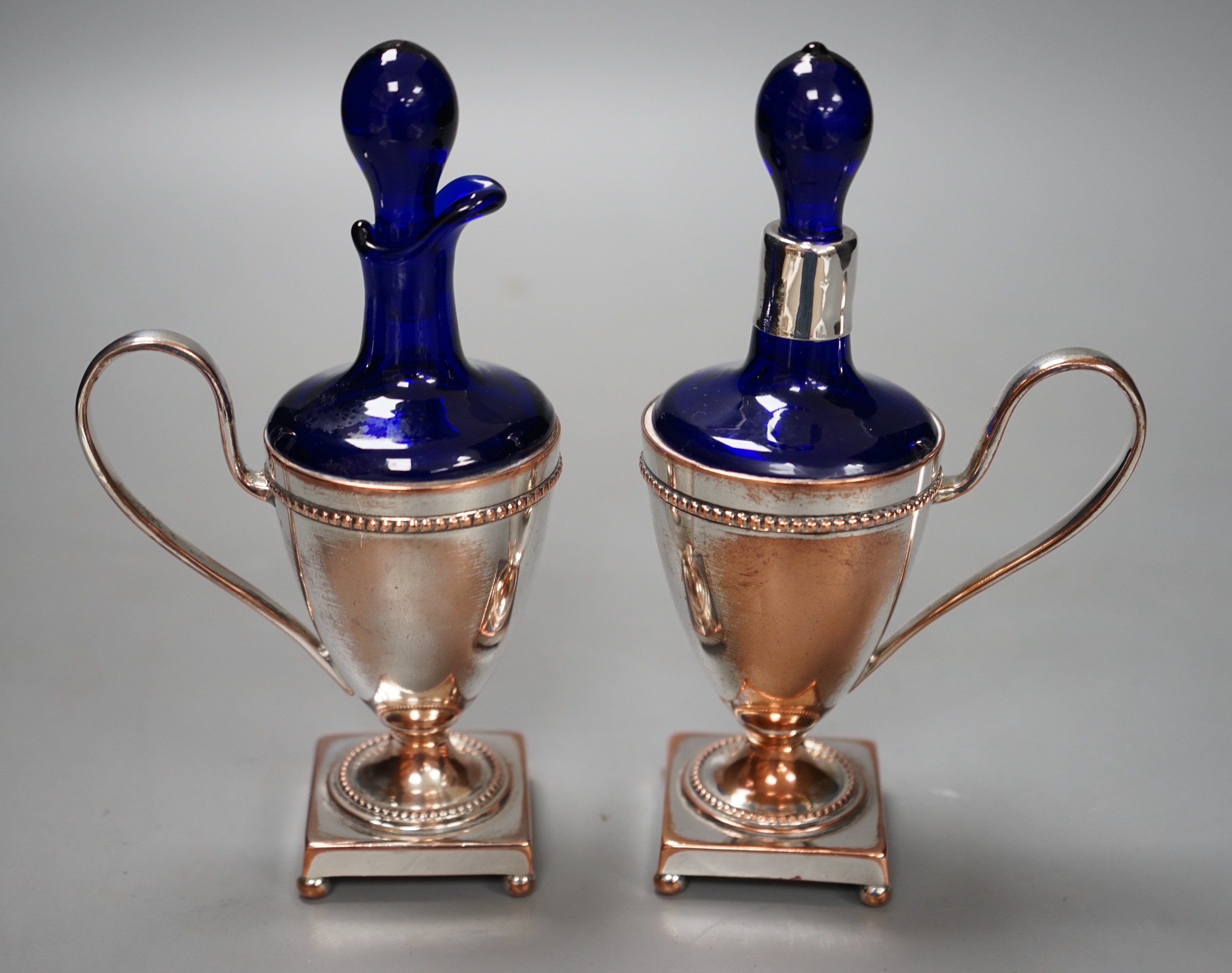 A pair of plate mounted blue glass scents, 16.5cm tall