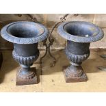 A pair of Victorian style painted cast iron campana garden urns, height 42cm