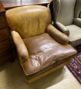 A Howard style faded brown leather club armchair, width 86cm, depth 108cm, height 74cm