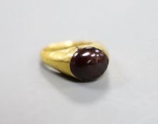 A Roman yellow metal and cabochon paste set ring, size J, gross weight 3.1 grams.
