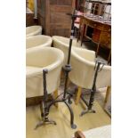 A wrought iron tripod pricket candlestick, height 138cm, together with a pair of andirons and a