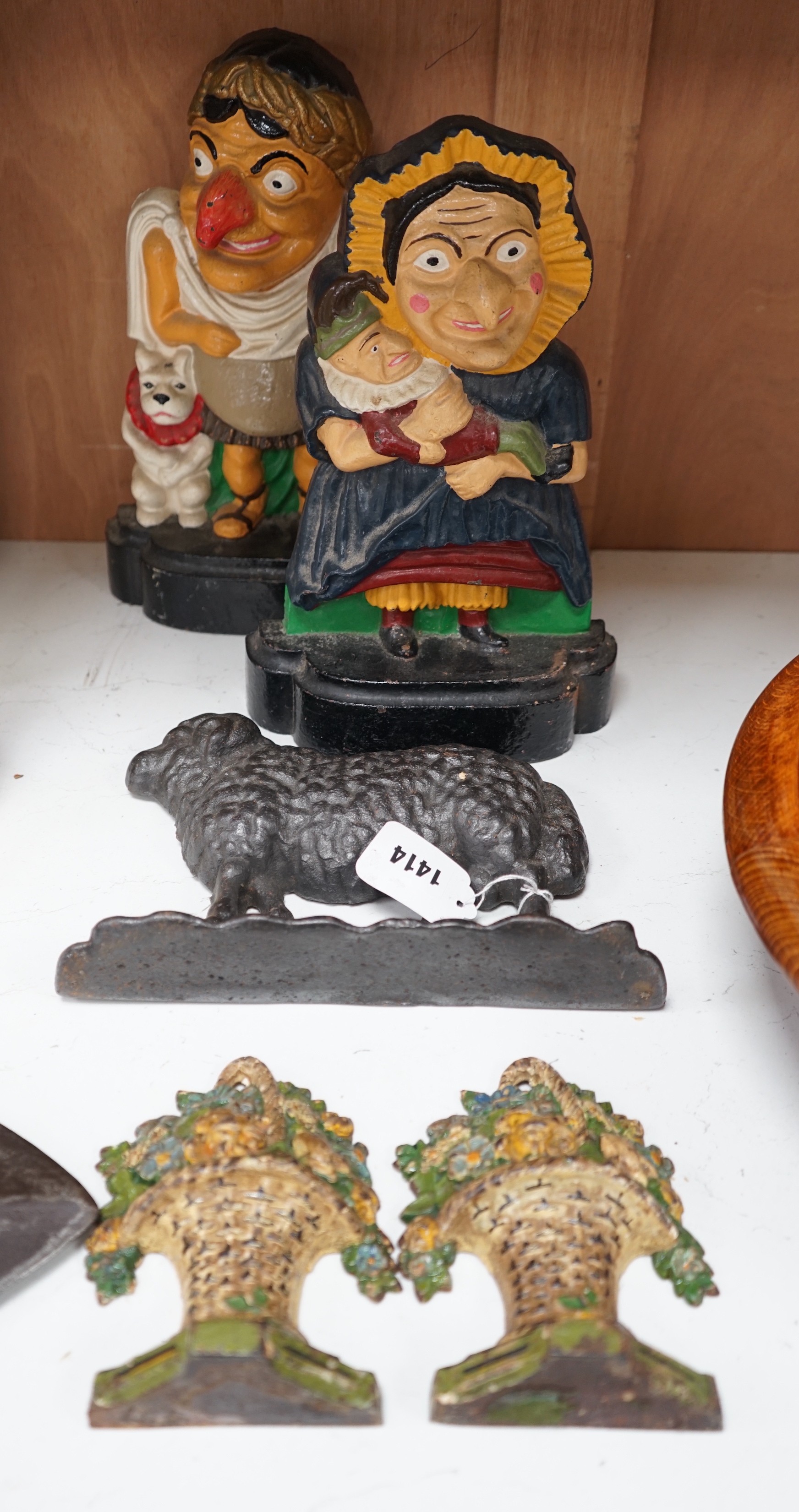 Five assorted cast iron doorstops including a pair of painted Punch and Judy and a pair of flower