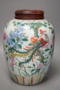 A 19th century Chinese famille rose 'phoenix' jar with wood cover, 30cm tall