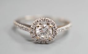 A modern 18ct white gold and single stone diamond ring with diamond chip circular setting and