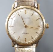 A gentleman's 9ct gold Longines Cosmic manual wind wrist watch, on associated flexible bracelet.
