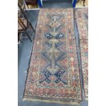 A pair of antique Caucasian blue ground rugs, 290 x 132cm