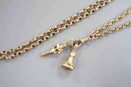 A late Victorian yellow metal guard chain, hung with a watch key and citrine set fob seal, 152cm,