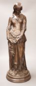After Boisseau, a tall bronzed metal figure of a standing maiden, signed to verso, 58cm tall