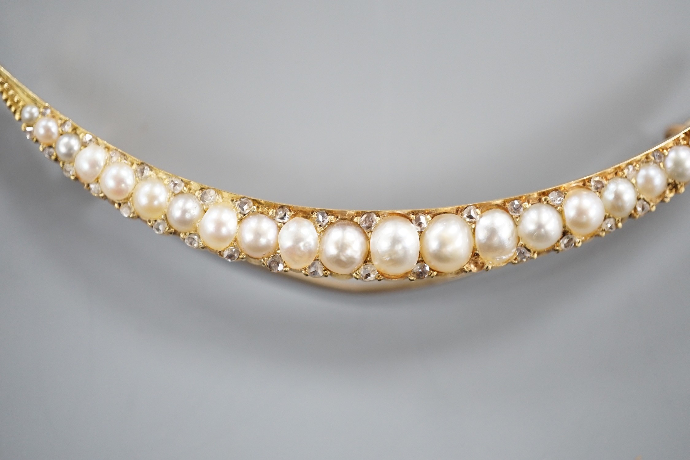 An early 20th century yellow metal and graduated split pearl set crescent brooch, with diamond - Image 3 of 5