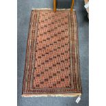 A Belouch red ground rug, 142 x 80cm