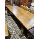 A reproduction 18th century style rectangular oak plank top refectory table, length 227cm, depth