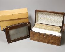 A Victorian walnut stereoscopic viewer and a quantity of slides