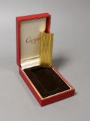 A Must de Cartier gold plated lighter, cased,7cms long,