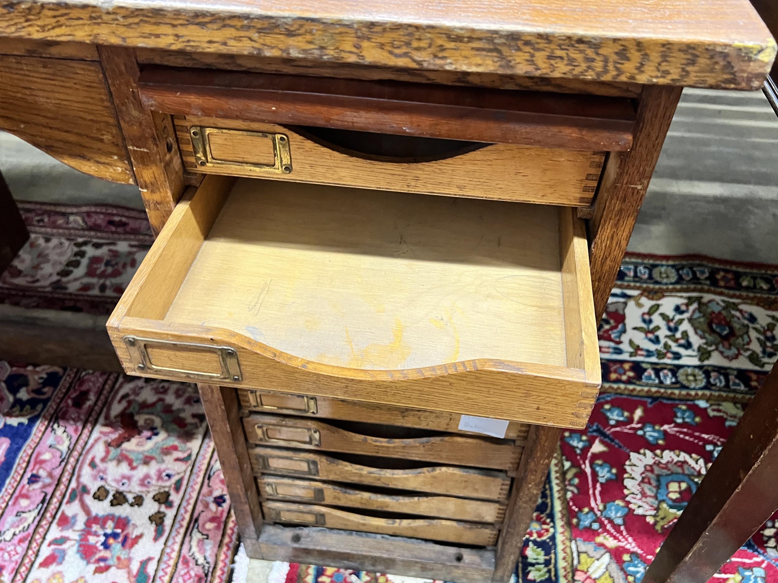 A mid 20th century oak kneehole desk fitted filing drawers, lacking tambour shutters, length - Image 3 of 3