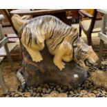 A painted stone garden ornament of a crouching tiger, tail detached, height 75cm