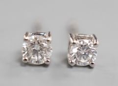 A modern pair of 9ct white gold and solitaire diamond set ear studs, gross 0.8 grams, total