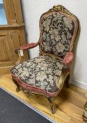 A 19th century French carved giltwood open armchair with floral tapestry upholstery, width 65cm,