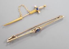 An early 20th French yellow metal (18ct poincon mark), sapphire and seed pearl set jabot pin,