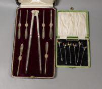 A George V cased set of six silver lobster picks and plated crackers and a similar set of silver and