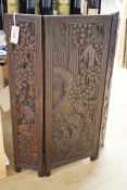 An Oriental three panelled carved wood folding screen, 84cm tall