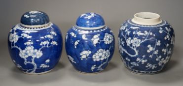 Three 19th century Chinese blue and white 'prunus' jars and two covers, 15cm