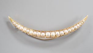 An early 20th century yellow metal and graduated split pearl set crescent brooch, with diamond